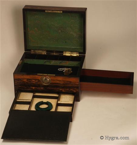 Ref: 635JB: Antique figured coromandel box with engraved mother of pearl escutcheons  working lock with key and having two sprung drawers  fitted for jewelry. The main part of the box has been relied with marbled paper and velvet. Circa 1850  Enlarge Picture